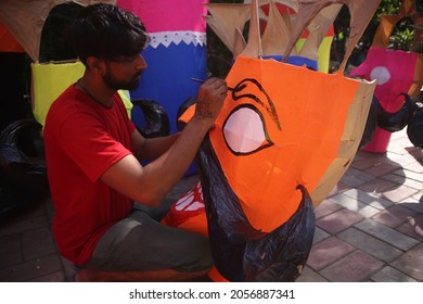 Delhi, India - 10-13-2021 - A Man Paints An Effigy Of The Demon King Ravana Ahead Of 'Dussehra' Festival Celebration In New Delhi.