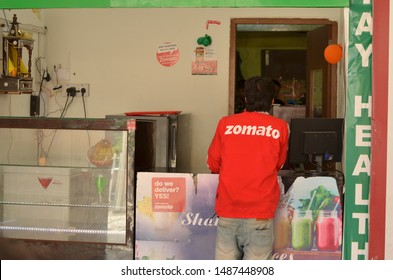 Delhi, India, 2020. Gurgaon Based Zomato, Food Delivery Boy Picking Order From A Restaurant. Online Food Delivery Startup In The Food-tech Space Acquired Uber Eats Competes With Swiggy