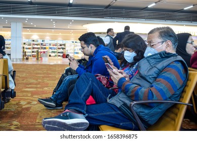 Delhi, India 2020 : Passengers Wesring Face Mask Amid Coronavirus Threat In The Waiting Lobby At The Airport. They Are Working In Their Mobile Phones. Countries Have Imposed International Travel Ban