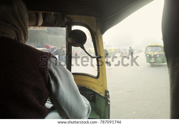 Delhi, India - December 18, 2015: day atmosphere in\
smog and taxi ride in\
Asia