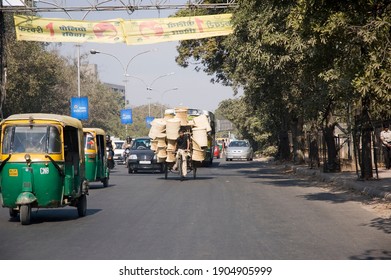 Delhi, INDIA - February, 2009: Cyclist In Delhi Riding A Bike Dangerously On Road Overloaded With Wicker Baskets