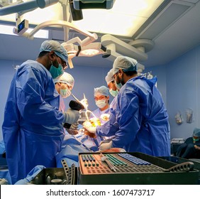 Delhi, India- January 6, 2020: Process Of Trauma Surgery Operation. Group Of Surgeons In Operating Room With Surgery Equipment. Medical Background.