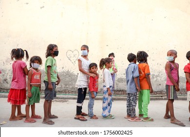 Delhi, India - May 16 2020 : Poor Children During Food Distribution By A Charitable Trust During Corona Pandemic.