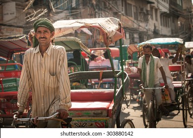 Delhi, India - September 18, 2014: Cycle rickshaw riding the vehicle under the heat on the street of Old Delhi, India on September 18, 2014.