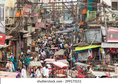 Delhi, India - September 7 2014: Many people and rickshaws move slowly in the very crowded streets of Old Delhi in India.