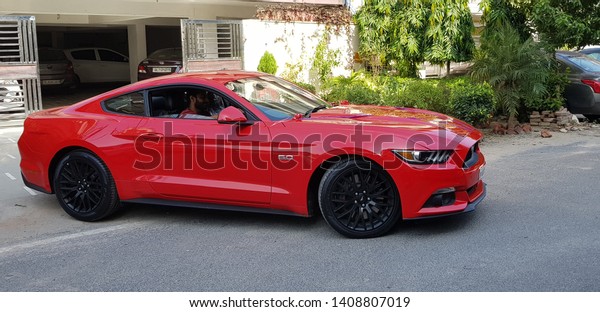 Delhi, India-10/01/2018: Ford Mustang ready to\
roll out. looks super amazing in red colour and black alloy wheels.\
the perfect muscle car. \
