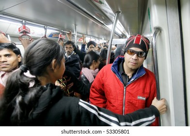 DELHI - JANUARY 19: Men And Women Standing In Crowded Train Carriage On January 19, 2008 In Delhi, India. Nearly 1 Million Passengers Use The Metro Daily.