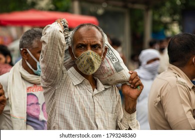 Delhi Uttar Pradesh Border, Delhi/India - Aug 8 2020: Migrants With Mask Carrying Luggage With Their Families Are Coming Back To City Search Of Work , Migrant From Bihar And Uttar Pradesh .