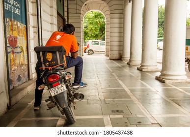 Delhi/India - Aug 25 2020 , Connaught Place Market During Lockdown . A Swiggy Food Delivery Boy Waiting For Order