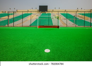 Delhi,India,March,31,2010: View Of Green Carpeted Field,goal Post,viewing Galleries  With Rows Of Colorful Plastic Chairs, Dhyanchand National Hockey Stadium, Delhi,India,