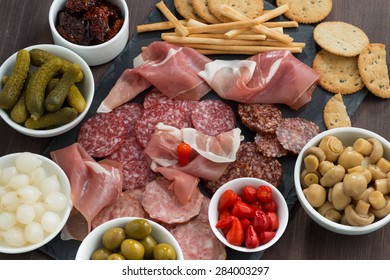 Deli Meat Snacks, Sausages And Pickles On A Blackboard, Close-up, Top View, Horizontal