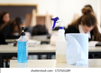 Deliberately Blurred Students In The Background Working On Classwork. Hand Sanitizer Sanitiser Pump With Disinfectant Spray Bottle In The Foreground. Corona Virus Covid 19 Education School Theme. 