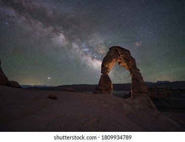 Delicate Arch light painted at night with the Milky Way Galaxy rising - Powered by Shutterstock