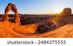 Delicate Arch - The most famous landmark of the Arches National Park in Utah in strong sunlight during sunset.