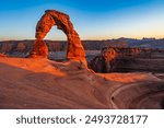 Delicate Arch - The most famous landmark of the Arches National Park in Utah in strong sunlight during sunset.