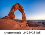 Delicate Arch - The most famous landmark of the Arches National Park in Utah after sunset in blue hour twilight.