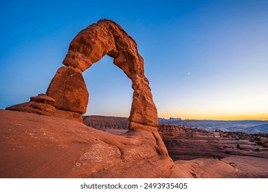 Delicate Arch - The most famous landmark of the Arches National Park in Utah after sunset in blue hour twilight. - Powered by Shutterstock