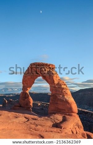 Delicate Arch on a Beautiful Sunny Day with the Moon Overhead at Arches National Park, Utah