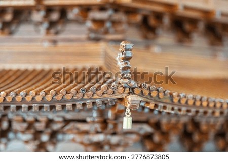 Delicate close up shot of upturned eaves on Chinese ancient architectural model