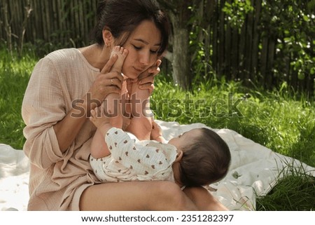 delicate embrace of a mother's lips pressed against her baby's tiny toes