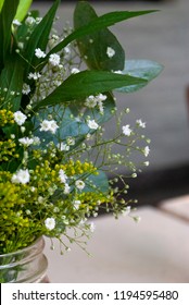 Delicate Floral Arrangement On Table In Restaurant For First Baptism Or First Communion In Central America. Guatemala.