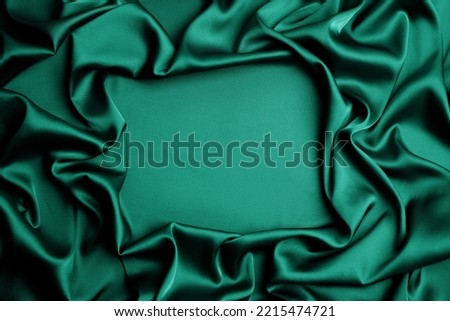 Delicate green silk fabric as background, top view. Space for text