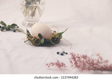 Delicate Nest Of Flowers Cradling An Egg, Easter Theme Background