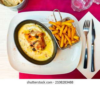 Delicate Savoyard Chicken Escalope Baked With Bacon And Zucchini In Creamy Sauce With Dry White Wine And Emmental Cheese, Served With Crispy Fries..