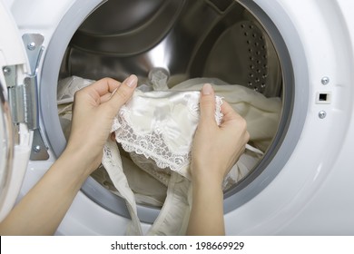 Delicate Wash, Female Hands Taking Delicate Laundry (underwear) From Washing Machine