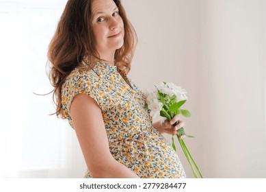 Delicate white blossoms complement expecting mother's gentle belly caress. Intimate moment of pregnancy joy and natural beauty.