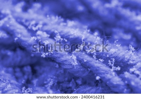 Delicate white snowflakes gently descend onto woolen knitted background, macro detail, winter romance and meteorological phenomena, seasonal changes Zdjęcia stock © 