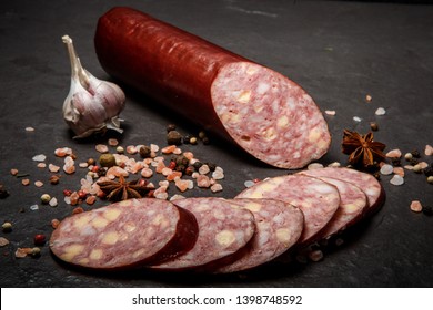 Delicatessen Sliced Jalapeno Cheddar Summer Sausage With Sliced Pieces Served With Pink Salt, Spices, And Whole Garlic