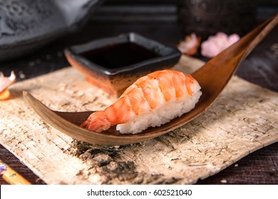 Delicious Ama Ebi Shrimp Nigiri Sushi (Shrimp Sushi) . Dish decorated with a sprig of cherry blossoms. Traditional Japanese cuisine.  - Powered by Shutterstock