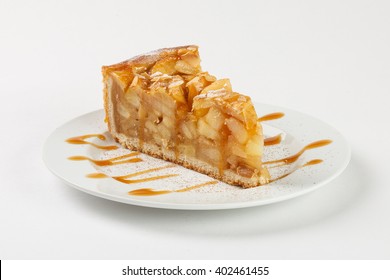 Delicious Apple Pie (charlotte) With Caramel On The Plate On White Background. Close Up Side View.