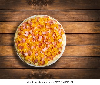 Delicious artisan pizza with fresh corn, pineapple and bacon