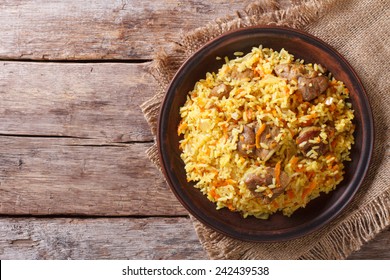 Delicious Asian Pilaf On A Brown Plate. Horizontal View From Above, Rustic Style 