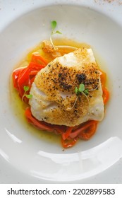 Delicious baked cod with roasted red pepper on wooden table. - Shutterstock ID 2202899583