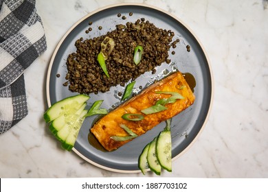 Delicious Baked Honey-soy Glazed Salmon Fillet Served With Black Beluga Lentils With Cucumber And Green Onions. Healthy Fresh Salmon Steak For Lunch Or Dinner. Top View