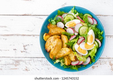 Delicious Baked Potato, Boiled Egg And Fresh Vegetable Salad Of Lettuce, Cucumber And Radish. Summer Menu For Detox Diet. Top View