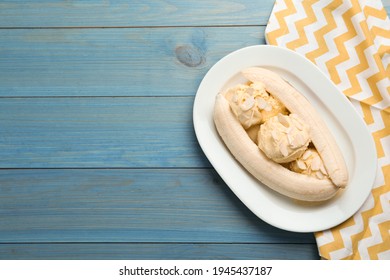 Delicious Banana Split Ice Cream On Light Blue Wooden Table, Top View. Space For Text