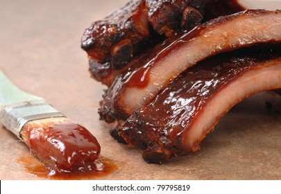 Delicious BBQ Baby-back Ribs With Tangy Sauce And A Sauce Brush