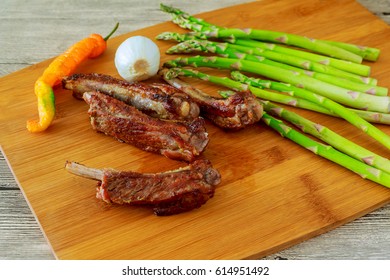 Delicious BBQ ribs with toasted bread, cole slaw and a tangy BBQ sauce pork ribs asparagus pepper - Shutterstock ID 614951492