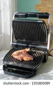 Delicious Beef Meat With Smoke Grilled In Cramped Kitchen