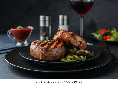 Delicious beef medallions served on black table