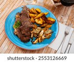 Delicious beef steak with baked potatoes and artichokes served at the plate