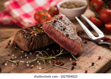Delicious beef steak on wooden table, close-up