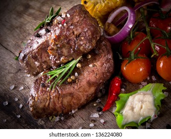 Delicious Beef Steaks On Wooden Table Stock Photo (Edit Now) 136223900
