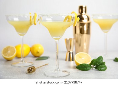 Delicious bee's knees cocktails and ingredients on light grey table