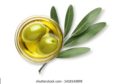 Delicious big green olives in an olive oil with leaves, isolated on white background, view from above