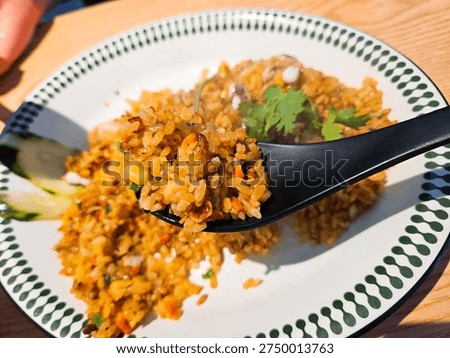 Delicious bite of authentic Com Chien, flavorful seafood fried rice with a bowl of Pho broth